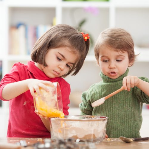 Two kids cooking at home.